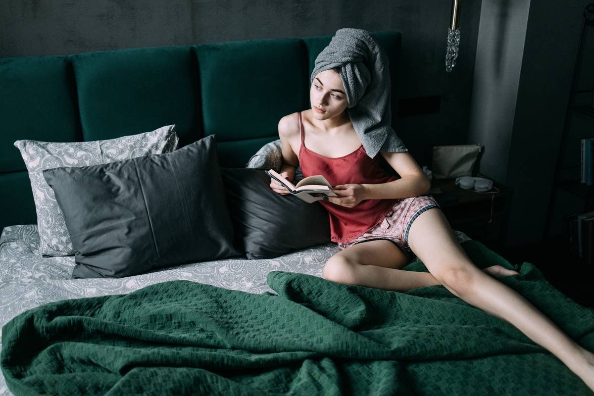 Woman wearing a satin sleep wrap to protect curly hair overnight